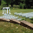 White garden chairs arranged for a wedding.