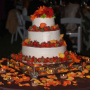 A white three-tiered cake accented with fresh strawberries.