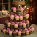 Five tiers of pink and chocolate cupcakes.